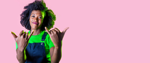 Rock'n'roll young black woman isolated background gesturing having fun smiling happy