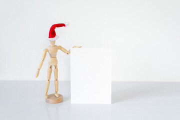 Christmas blank greeting card mock-up scene. Wooden mannequin posing on greeting card or gift list...
