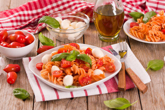 Fusilli pasta with cherry tomatoes and mozzarella cheese.