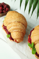 Concept of delicious food with croissants with raspberry jam on white background
