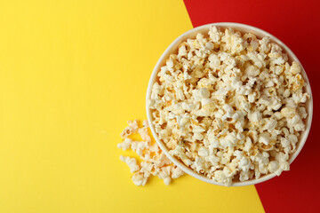Striped paper cup with popcorn on two tone background