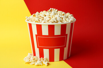 Striped paper cup with popcorn on two tone background © Atlas