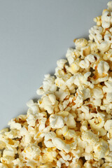 Tasty popcorn on light gray background, space for text
