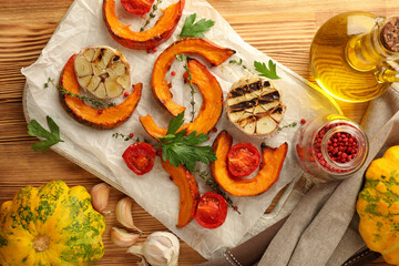 Concept of cooking with baked pumpkin on wooden background