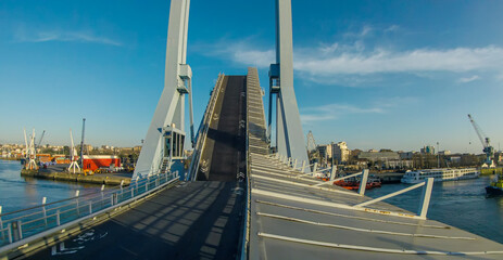 Photo of the drawbridge descending after the passage of the ship on a sunny day in port Leoxioes Portugal