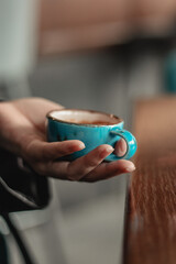 Fototapeta na wymiar A cup of espresso in hand