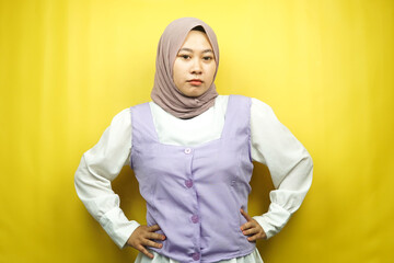Beautiful young asian muslim woman pouting, angry, feeling annoyed, dissatisfied, uncomfortable, feeling bullied, lied to, looking at camera isolated on yellow background