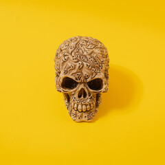 Halloween skull with shadows against illuminating yellow background. modern abstract art. modern concept. minimalism.