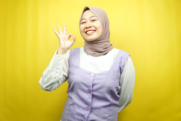 Beautiful young asian muslim woman smiling confident, enthusiastic and cheerful with hands ok sign,...