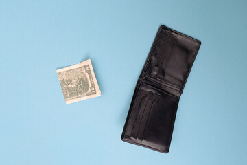 Wallet and two dollars lie on a blue background. Bankrupt. Money is tight. Importance of savings. Financial aid concept.