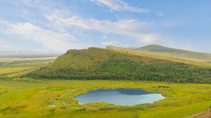 Fototapeta na wymiar Mountain view the Second and Third Sunduki and a small lake at the foot. Landscape of the Sunduki mountain range located in the valley of the Bely Iyus River in Khakassia, Russia.