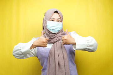 Muslim women wearing medical masks, anti corona virus movement, anti covid-19 movement, health movement using masks, with hands showing ok sign, good work, success, victory, isolated