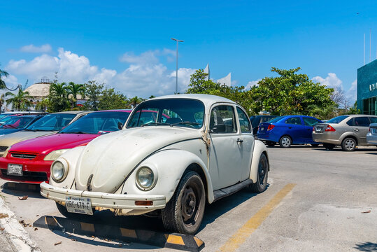 Cancun, Mexico. May 30, 2021. Old vintage car parked in a row with other cars roadside