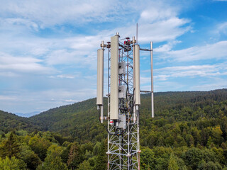 Aerial drone view of GSM and radio telecommunication tower in mountains. Cell phone tower. Base...