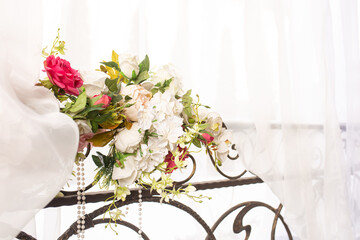 A bouquet of flowers and ribbons tied as a wedding decoration