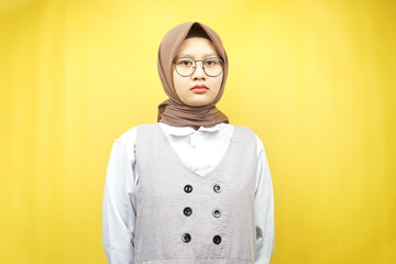 Beautiful asian young muslim woman looking at camera isolated on yellow background