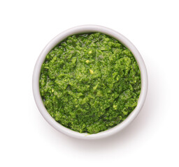 Top view of green pesto sauce in ceramic cup