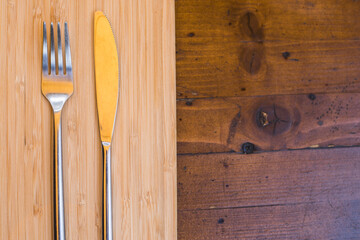 Knife and fork on a wooden table