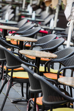 Empty chairs and tables at an open air terrace