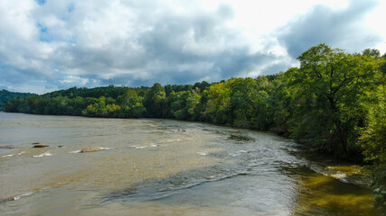 a stunning aerial shot of the Chattahoochee river surrounded by lush green and autumn colored trees...
