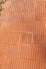 Vertical texture of orange tiles on the sidewalk abstract background
