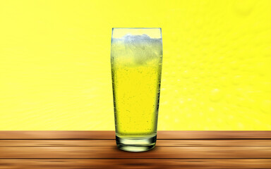 orange juice with ice in a glass on a yellow background