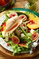 Still life with fruit salad on wooden background