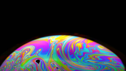 Colorful close-up of soap bubble on black background, iridescence phenomenon, looks like rising...