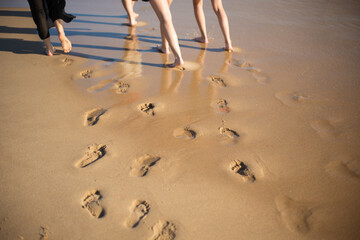 Footprints at sand. Footsteps at wet sand, children and adults. Family, vacation, outdoor activity...