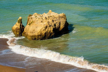 emerald sea, beautiful beach, rock and cliffs at Dona Ana beach in Lagos, Algarve, Portugal