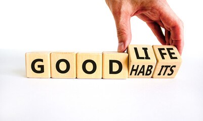 Good habits and life symbol. Businessman turns wooden cubes and changes words 'good habits' to 'good life'. Beautiful white background, copy space. Business and good habits and life concept.