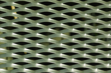Silver metal pattern with holes (wall fence) makes for a beautiful background