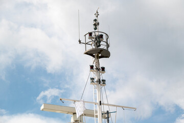 Antennas and lighting on a ship mast.