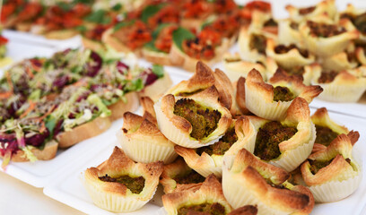 Snack muffins with meat on a table for take away as a gourmet meal. Food in form of buffet on party or banquet. Colorful healthy eating. Close up.