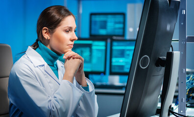 Workplace of young woman in modern microelectronics manufacturing lab. Engineer works in a modern...