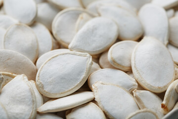 Pumpkin seeds in a shell close-up, macro as a background.