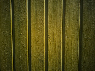 Yellow background. Painted plank wall.