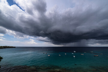 Thundershower scenery with flying clouds over the turquoise sea around Curacao, the Caribbean