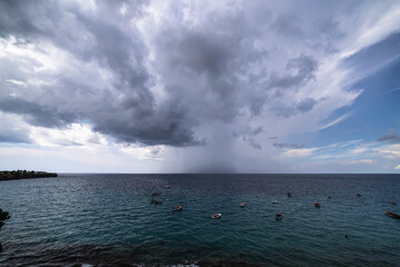 Thundershower scenery with flying clouds over the turquoise sea around Curacao, the Caribbean