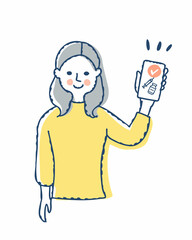 スマートフォンでワクチンパスポートを見せている女性