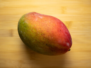 Mango on a bamboo board. Flat lay, top view.