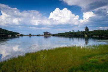 Bezbog hut in Pirin mountain Bulgaria with Bezbog lake on sunrise and sunset with rainbow