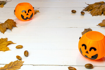 Halloween pumpkins on autumn leaves, background of the autumn festive concert