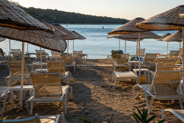 empty sunbeds on the sea shore, top view