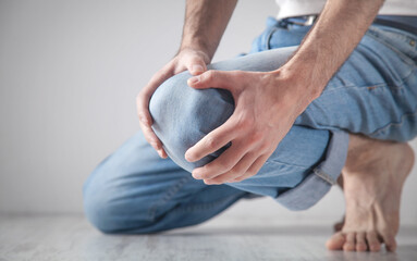 Caucasian man suffering from knee pain.