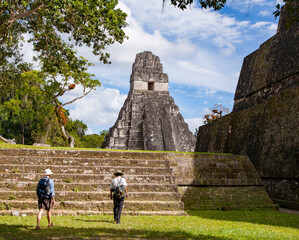 Tourists moving towards the Temple of the Jaguar in the city of Tikal in Guatemala