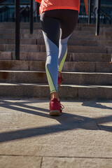 Fototapeta na wymiar Vertical shot of sporty woman run outdoors