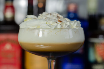 Alcoholic coffee cocktail with a nutty note and whipped cream