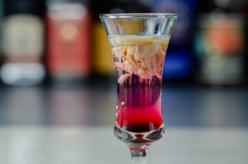 Interesting drink shot based on cream, liqueur and grenadine called Brain Hemorrhage prepared for...