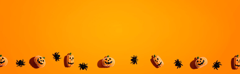 Miniature Halloween pumpkin ghosts with spiders - flat lay